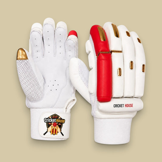 Cricket House premium batting gloves in white with red and gold accents, featuring split-finger design and grip palm.
